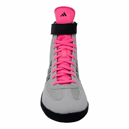 Wrestling shoe with pink laces and ankle strap.